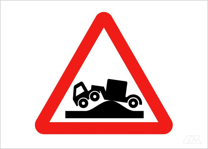 Caution sign shows a silhouette of an articulated truck grounded on a hump