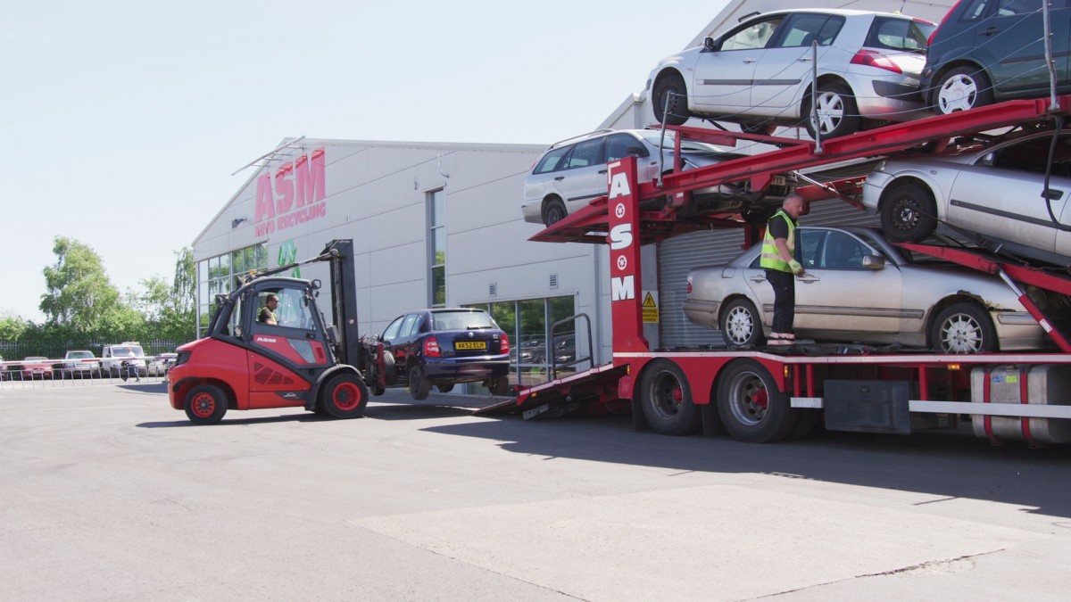 ASM scrap car transporter at HQ with forklift offload