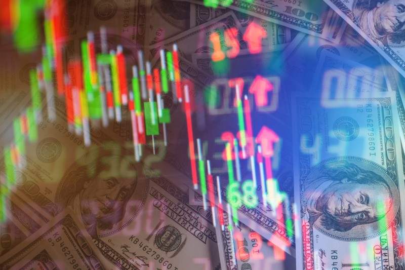 Composite image of stock market charts and dollar bills