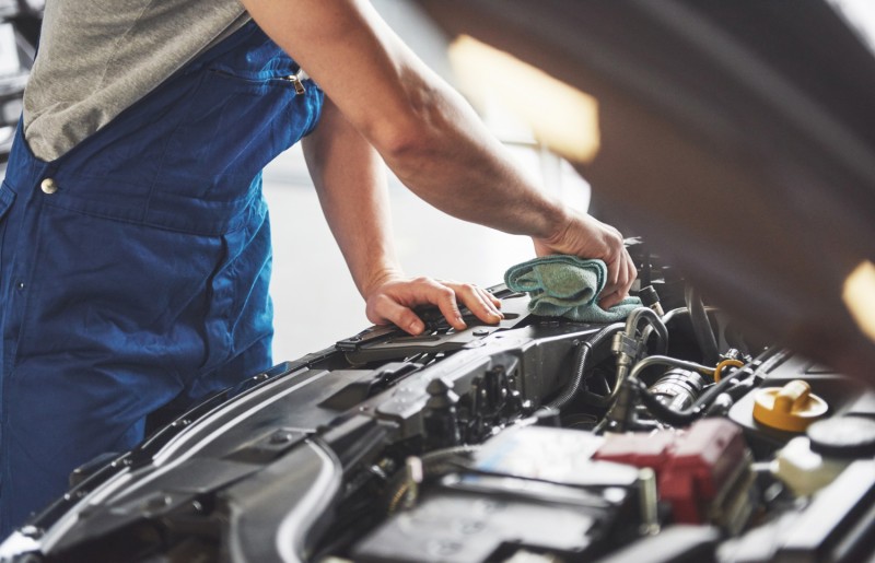 Car mechanic working in a garage