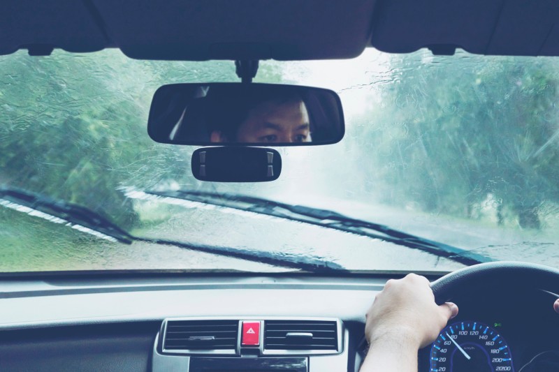 Man driving car in heavy rainfall