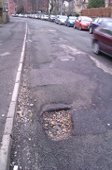 Pothole in the road. Photo by Duncan Hull (CC BY 2.0)