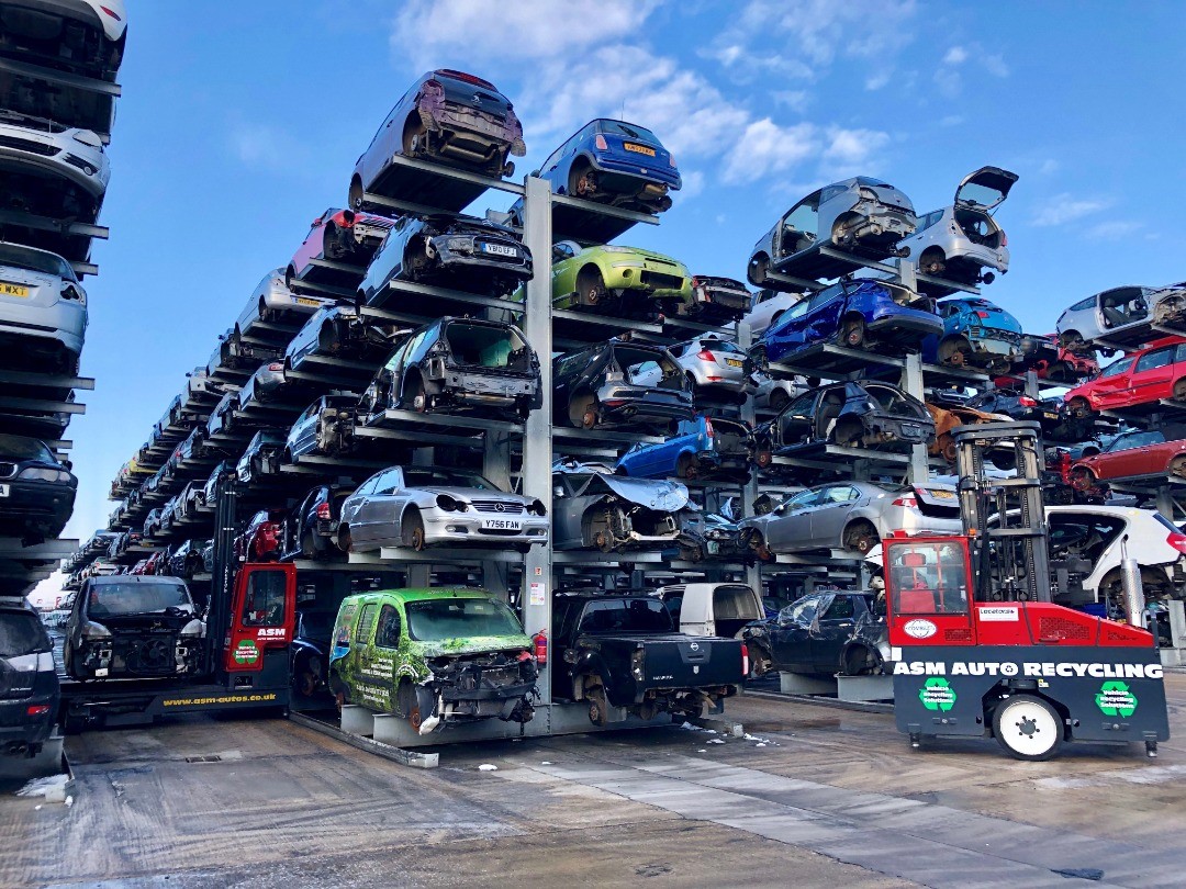 Fully stocked car racks with forklifts in ASM's compound