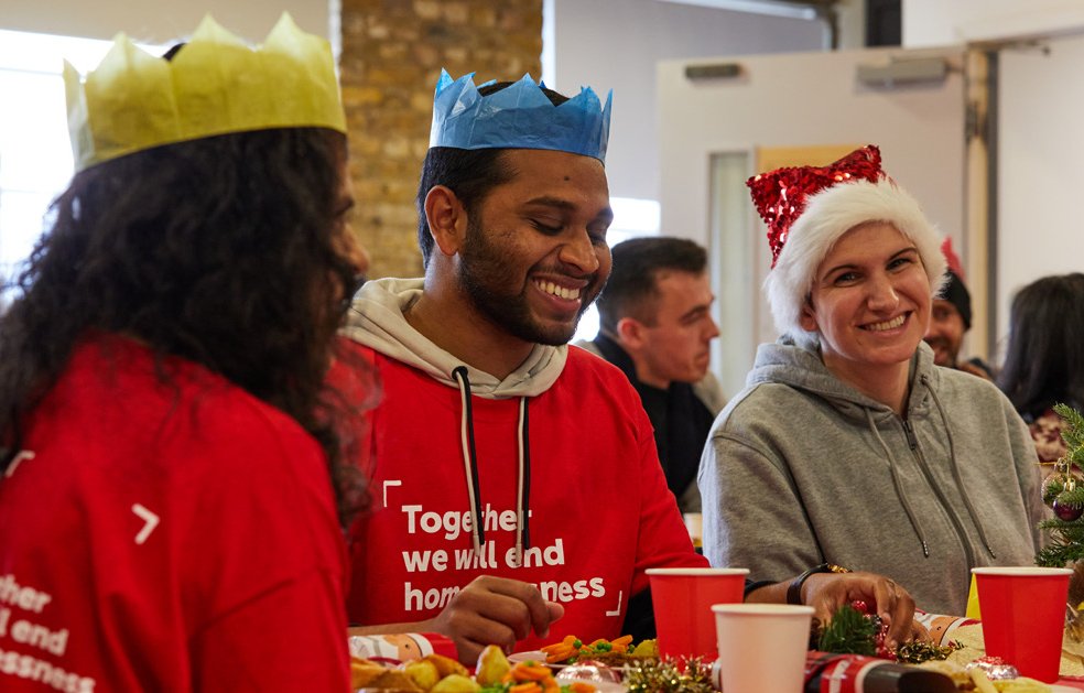 People enjoying a meal around a table for Crisis at Christmas