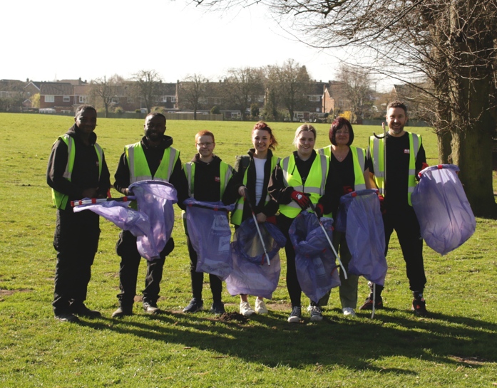 ASM Auto Recycling staff in a park with empty waste sacks and pickers